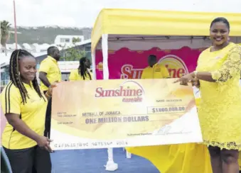  ?? (Photos: Dwayne Richards) ?? Sunshine Cereals Brand Manager Keisha Prince (right) presents the symbolic million-dollar cheque to Netball Jamaica Vice-president Tricia Williams at the launch of the Sunshine Cereals/netball Jamaica Intermedia­te League.