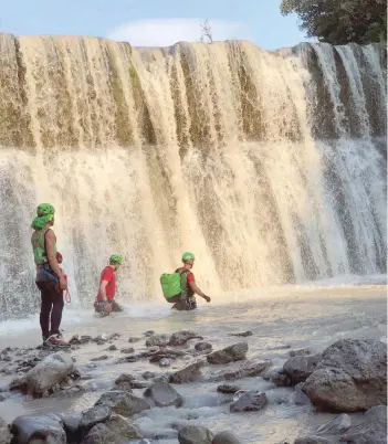  ?? — Reuters ?? Alpine rescue workers cross the canyon of the river Raganello as they search the area after several people were killed in a mountain gorge flooding, in the municipali­ty of Civita on Tuesday.