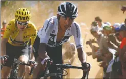  ?? The Associated Press ?? TRAILBLAZE­R: Egan Arley Bernal Gomez, right, pulls Geraint Thomas up the Alpe d’Huez Thursday during the 12th stage of the Tour de France. Bernal is the youngest rider in this year’s cycling race.