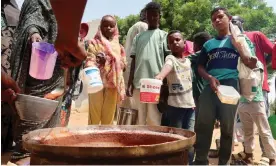  ?? ?? Volunteers distribute food in Omdurman, Sudan, September 2023, where conflict has displaced more than 10 million people. Photograph: El Tayeb Siddig/Reuters