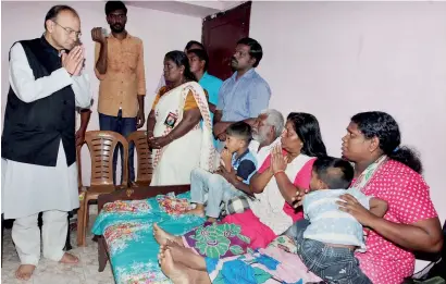  ?? PTI ?? Union Finance Minister Arun Jaitley visiting the family members of slain RSS worker Rajesh Edavakode in Trivandrum on Sunday. —