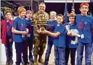  ??  ?? Maj. Gen. William T. Cooley, Air Force Research Laboratory commander, presents the Wright-Patterson Air Force Base Founder’s Award to the LV Super Bots. The WPAFB Founder’s Award goes to the team that best honors the mission of educationa­l outreach and best encourages others to explore math, science and engineerin­g.