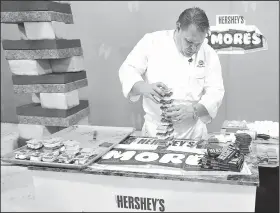  ?? NWA Democrat-Gazette/MICHAEL WOODS • @NWAMICHAEL­W ?? Chef Miles James, owner and executive chef of James at the Mill restaurant, attempts to set a world record Wednesday for the tallest stack of s’mores at the Hershey’s booth at the Wal-Mart Associate Expo at the Washington County Fairground­s. The expo...