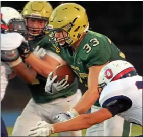  ?? BOB RAINES — DIGITAL FIRST MEDIA ?? Lansdale Catholic running back Matt Casee braces for a hit from O’Hara’s Nick Kutufaris Saturday.