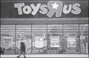  ?? AP PHOTO ?? A person walks near the entrance to a Toys R Us store in Wayne, N.J.