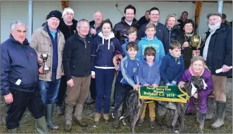  ??  ?? Jimmy Browne and Mike Slattery presenting the cup to Maire and Michael Fields and family after Maire’s dog, Kyle Mozart, won the Kit Browne Cup at Ballyduff Coursing on Sunday last