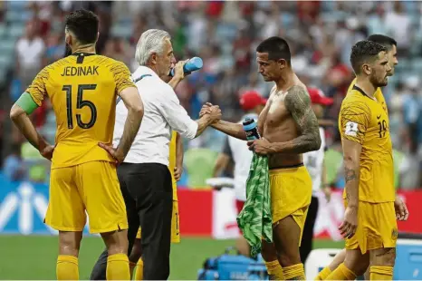  ?? — AP ?? Thank you: Australia coach Bert van Marwijk (second from left) shaking hands with Tim Cahill after the Group C match against Peru at the Fisht Stadium on Tuesday.
