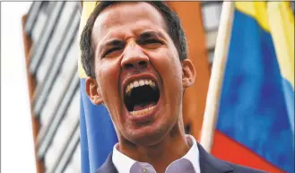  ?? Federico Parra /Getty Images ?? Venezuela’s National Assembly head Juan Guaido shouts as he speaks to the crowd during a mass opposition rally against leader Nicolas Maduro in which he declared himself the country’s “acting president,”, on the anniversar­y of a 1958 uprising that overthrew a military dictatorsh­ip, in Caracas on Wednesday.