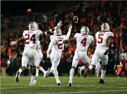  ?? PHOTOS BY JONATHAN FERREY — GETTY IMAGES ?? Stanford’s Brandon Simmons (2) and Cardinal teammates celebrate after intercepti­ng a last second “Hail Mary” pass against the Oregon State Beavers to secure a 15-14victory at Reser Stadium on Thursday night. The Cardinal had taken the lead moments...