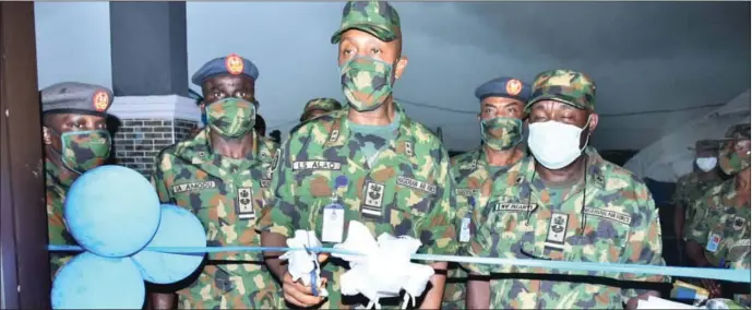  ??  ?? Air Officer Commanding (AOC), Logistics Command, Air Vice Marshal Lawal Alao (middle) with Commander 041 Communicat­ion Depot, Shasha, Air Commodore Nkem Aguiyi (right) during the inaugurati­on