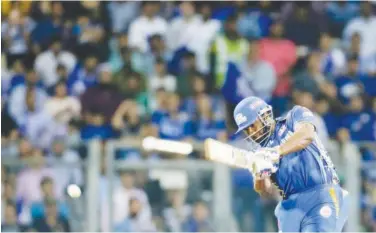  ?? Associated Press ?? ↑ Mumbai Indians’ Kieron Pollard plays a shot against Kings XI Punjab during their IPL match in Mumbai on Wednesday.