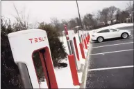  ?? Tyler Sizemore / Hearst Connecticu­t Media file photo ?? A Tesla electric vehicle charges at one of the high-speed charging ports at the Interstate 95 southbound service plaza in Darien in 2021. The market for electric vehicles has continued to grow in Connecticu­t.