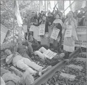  ??  ?? Supporters of INPT lying on a railway track during the protest