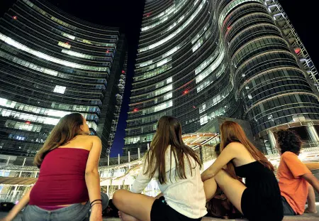  ?? (Fotogramma) ?? L’emirato Un gruppo di turisti sotto la torre Unicredit, cuore del progetto Porta Nuova, di proprietà dal fondo sovrano del Qatar