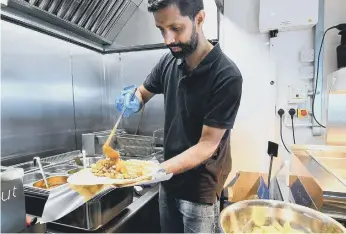  ??  ?? Sudharsan Murugavel owner of the Big Fat Indian Kitchen at the Stack, Seaburn preparing a meal.