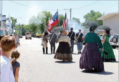  ??  ?? The audience looked on in awe last year as Turkey Creek Fusiliers fired a Civil War-era shot into the sky. Lovely ladies in correspond­ing garb charmed the crowd.