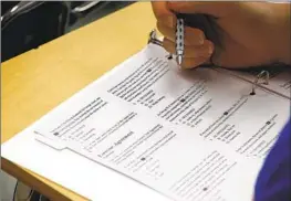  ?? Alex Brandon Associated Press ?? A STUDENT looks at questions during a college test preparatio­n class at HoltonArms School in Bethesda, Md., in 2016.