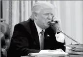  ?? ASSOCIATED PRESS ?? IN THIS PHOTO TAKEN JAN. 28, President Donald Trump speaks on the phone with Australian Prime Minister Malcolm Turnbull in the Oval Office of the White House in Washington.