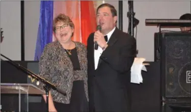  ?? KEITH REYNOLDS — THE MORNING JOURNAL ?? Marcy Calvert laughs along with Dr. Alexander Zolli after being awarded the 2018 Alex and Maria Zolli Living Angel Award at the 32nd annual Life Savers Ball on March 3, at the Emerald Event Center, 33040 Just Imagine Drive in Avon.