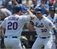  ?? MARK LENNIHAN ?? New York Mets’ Pete Alonso, left, is met at home plate by teammate Michael Conforto after hitting a two-run home run against the Miami Marlins in the first inning of a baseball game, Wednesday, Aug. 7, 2019, in New York.