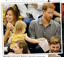  ??  ?? Sleight of hand: Emily sneaks popcorn