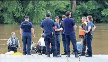  ?? / Spencer Lahr ?? Emergency first responders wait on the boat dock at Heritage Park while other crews hit the river to make sure everyone who participat­ed in Rome’s Big Float is off the river Saturday afternoon.