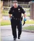  ?? Houston Chronicle ?? An officer carries a pellet gun taken from a man police shot Sunday.