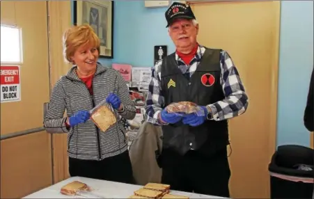  ?? REBECCA BLANCHARD — DIGITAL FIRST MEDIA ?? Sen. Judy Schwank with Bill Lutz, member of the Oley American Legion Post 878, making lunches for Hope Rescue Mission of Reading.