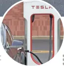  ?? CHUCK BURTON, AP ?? A Tesla car recharges at a charging station in Charlotte, N.C. Tesla CEO Elon Musk says the company expects to reach production of 20,000 Model 3 cars per month in December.
