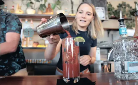  ??  ?? CASSANDRA Eichhoff mixes a Bloody Maria (Altos Bloody Mary) at a Collective Spirit competitio­n open to Bartenders in Maboneng, Johannesbu­rg. | African News Agency/ANA