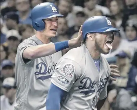 ?? Robert Gauthier Los Angeles Times ?? YASIEL PUIG, with Cody Bellinger behind, is exuberant after hitting a three-run home run in the sixth inning for the Dodgers. Bellinger hit a two-run home run in the second inning to start the Dodgers on the way to a 5-1 victory and a trip to the World Series.