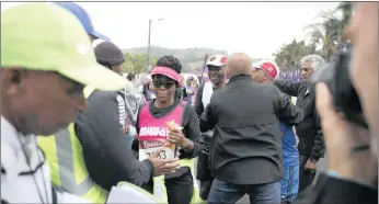  ?? PICTURE: DOCTOR NGCOBO/AFRICAN NEWS AGENCY(ANA) ?? While a runner just makes it through the Drummond halfway point as the gun went off for the cut off, many others were left dissappoin­ted.