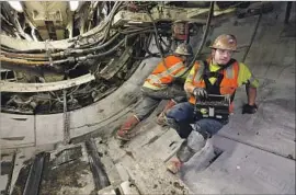  ?? Mel Melcon Los Angeles Times ?? WORKERS on Metro’s Regional Connector project assemble a section of tunnel beneath downtown L.A. The transit agency had set a target of December 2020.