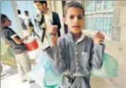  ??  ?? A boy carries food supplies provided by the World Food Programme at a school in Sanaa, Yemen. AP/FILE