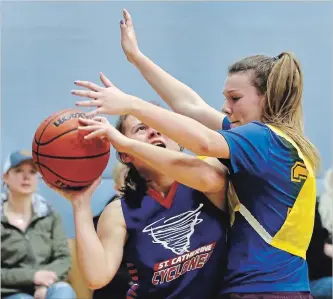  ?? CLIFFORD SKARSTEDT EXAMINER ?? St. Catherine Cyclones’ Samantha Seiderer is pressured against St. Alphonsus during the Holy Cross Family of Schools intermedia­te girls basketball tournament Thursday at Holy Cross Secondary School.