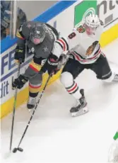  ?? GETTY IMAGES ?? Dominik Kubalik (right), battling for the puck against the Golden Knights’ Nate Schmidt, emerged as a star for the Hawks this season.