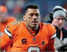  ?? PHOTOS BY ANDY CROSS — THE DENVER POST ?? Denver Broncos quarterbac­k Russell Wilson (3) comes off the field after losing to the New England Patriots 26-23 at Empower Field at Mile High in Denver on Sunday, Dec. 24, 2023.