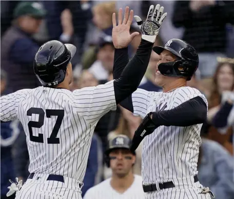  ?? Ap ?? MEET AT THE PLATE: New York Yankees' Giancarlo Stanton celebrates with Aaron Judge, right, after hitting a tworun home run off Nick Pivetta in the sixth inning of their 4-2 win over the Red Sox.