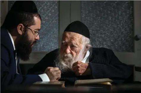  ?? The New York Times/Dan Balilty) ?? Rabbi Chaim Kanievsky (center), whose pronouncem­ents have made him one of the most controvers­ial figures in Israel today, with his grandson Yaakov Kanievsky, at the rabbi’s home in Bnei Brak, Israel.