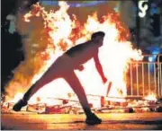  ?? AFP ?? A Palestinia­n protester hurls stones at Israeli security forces in Jerusalem’s Old City on Saturday night.