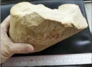  ?? ZHAOYU ZHU — THE ASSOCIATED PRESS ?? This Sunday, Jul. 30, 2017 photo provided by Zhaoyu Zhu shows a big core of quartzite rock found in the Loess Plateau in China. In a report released on Wednesday, July 11, 2018, scientists think that this rock was struck to create flakes with sharp...