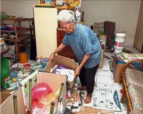  ??  ?? Hard life: Lee sorting recyclable items inside her house.