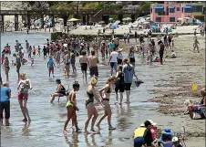  ?? STAFF FILE PHOTO ?? Capitola Beach visitors bask in the sun, sand and water of Monterey Bay on June 10. Last month marked Earth’s hottest June on record.