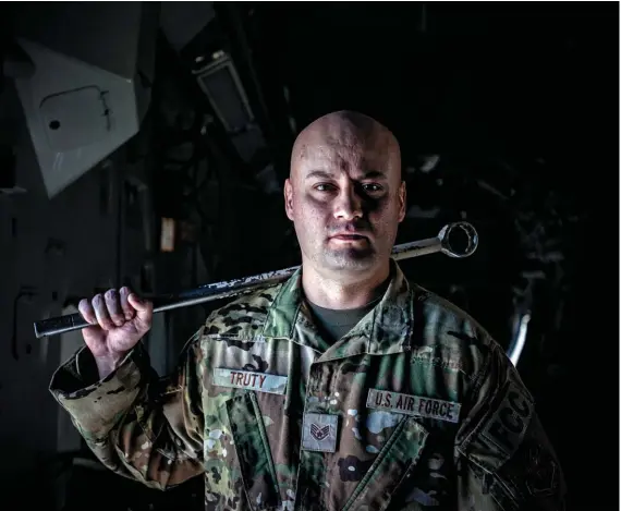  ?? ?? Staff Sgt. Christophe­r Truty, one of the loadmaster­s who carefully packed 270 refugees aboard the 6th Airlift Squadron's C-17.