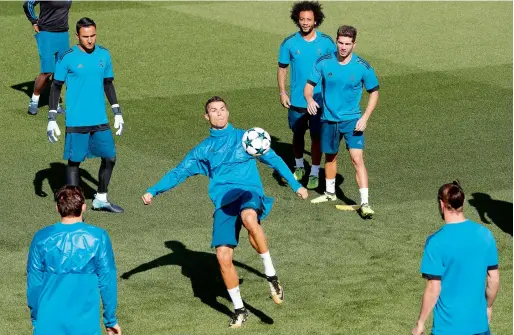  ?? Reuters ?? Real Madrid’s Cristiano Ronaldo, Marcelo and teammates during training. —