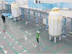  ??  ?? A worker cleans the floor in a bioreactor hall at Plant 3.