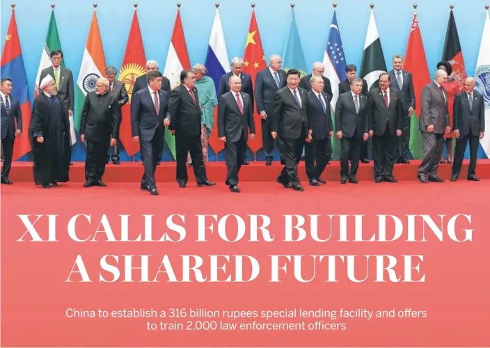  ?? XU JINGXING / CHINA DAILY ?? President Xi Jinping and leaders attending the 18th Shanghai Co-operation Organisati­on Summit pose for a group photo on June 10 in Qingdao, Shandong province.