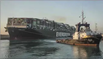  ?? SUEZ CANAL AUTHORITY VIA AP, FILE ?? In this photo released by Suez Canal Authority, the Ever Given, a Panama-flagged cargo ship, is pulled by one of the Suez Canal tugboats, in the Suez Canal, Egypt, on March 29, 2021.