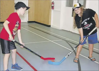  ?? lyNN CurwiN/Truro Daily News COver phOTO By Lynn Curwin/TrurO daiLy news ?? Lucas Dean and Chloe Garcia are ready for a faceoff. The children take part in Boys & Girls Club programs and are enjoying the larger gym in the Douglas Street location. Owen Paris, left, and Kyah Lovell enjoy building with Lego at the Boys & Girls...