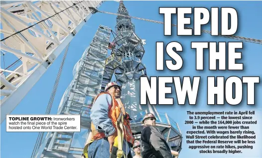  ??  ?? TOPLINE GROWTH: Ironworker­s watch the final piece of the spire hoisted onto One World Trade Center.